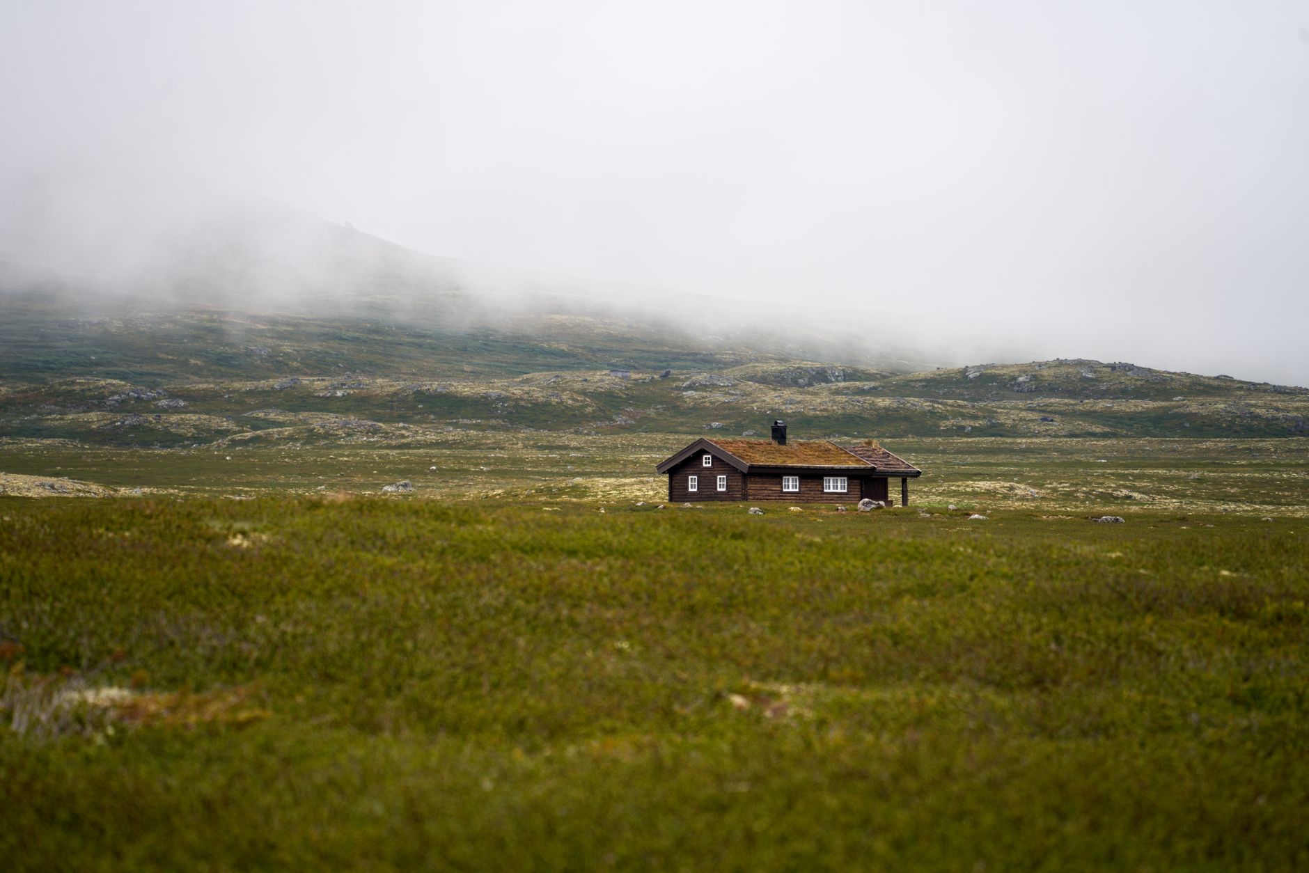 Norwegian fjord with isolated wooden architecture at dusk